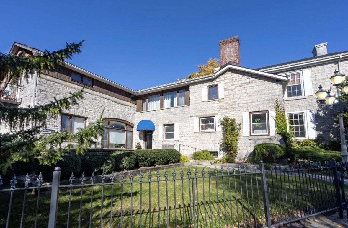 Please use the side door with the blue awning.